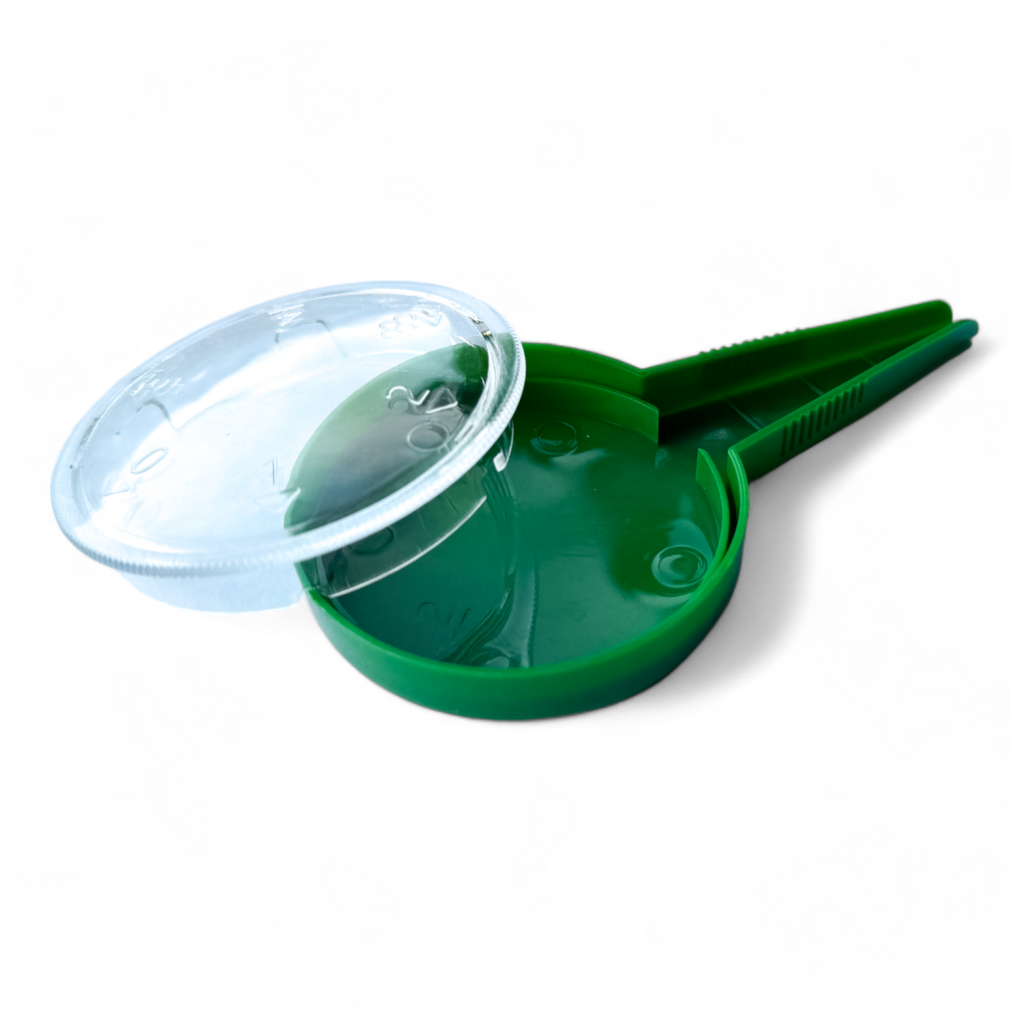 Portable seed dispenser with removed lid and spoon on white table