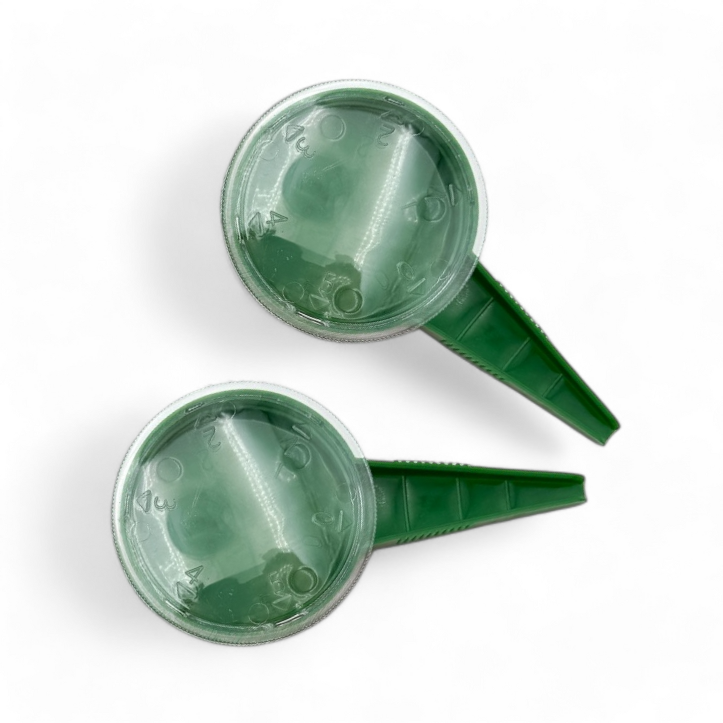 Two reusable green seedling pots with secure lids, arranged neatly on a white surface