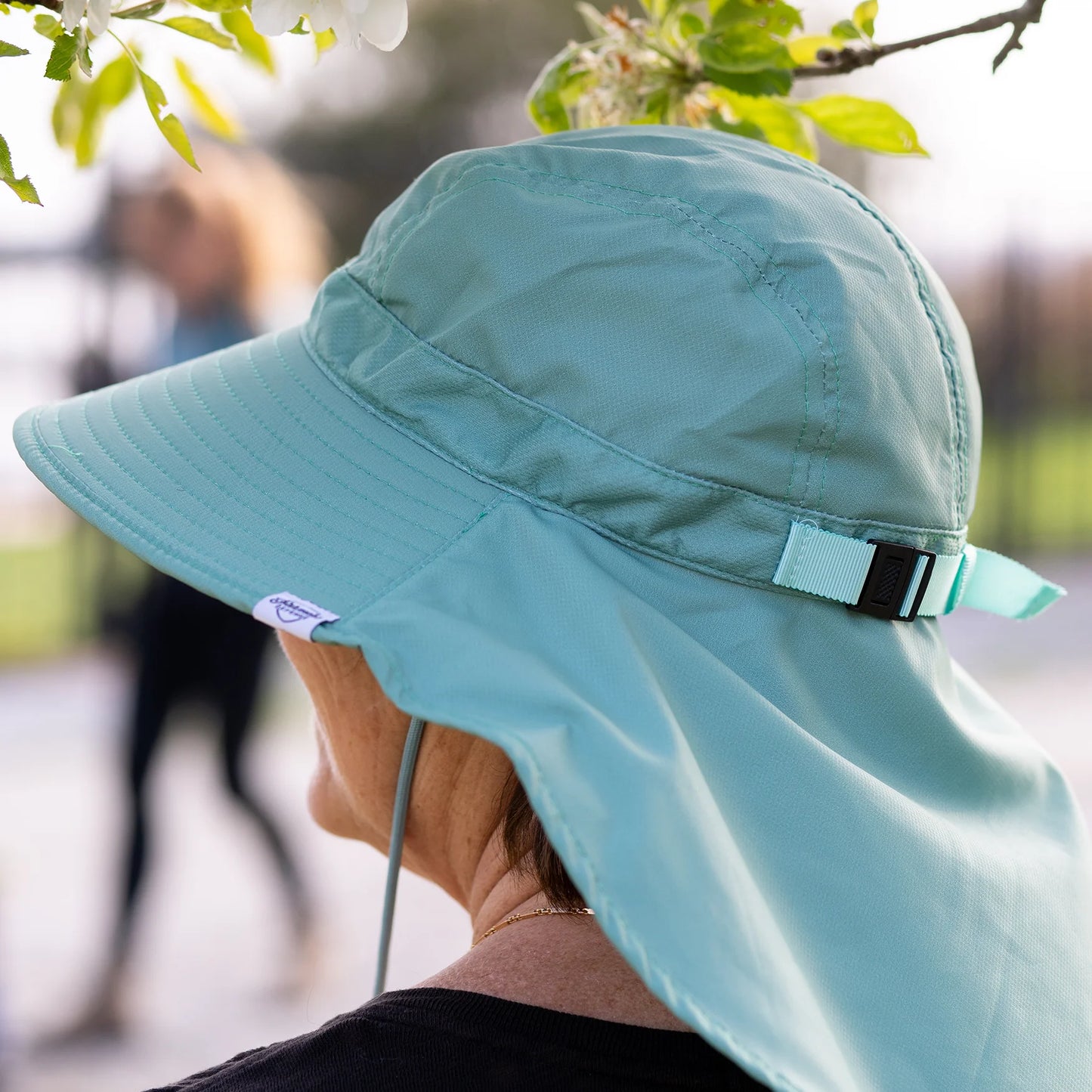 Female model in wearing the Farmers Defense green sun hat