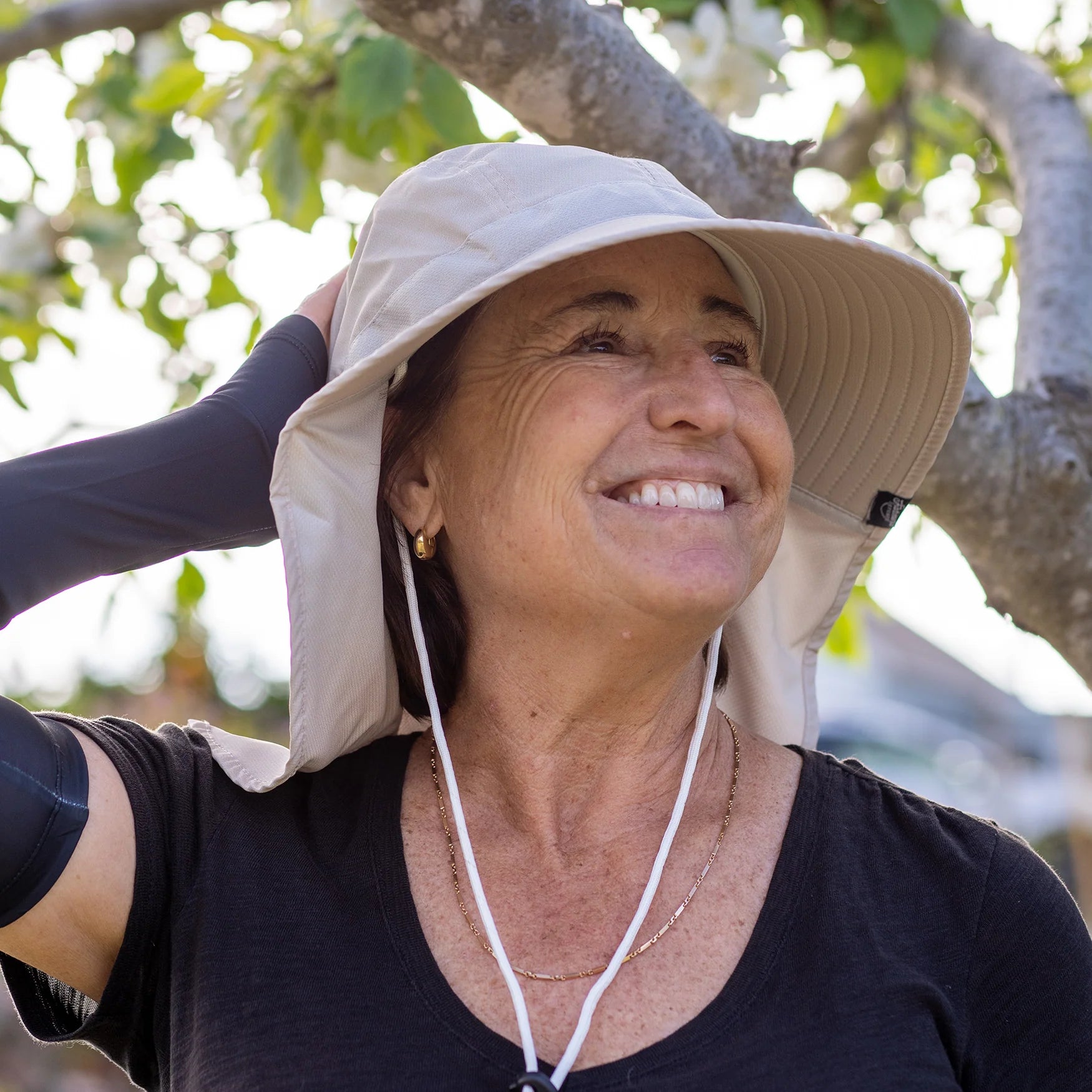 Female model sporting the white Farmers Defense sun hat