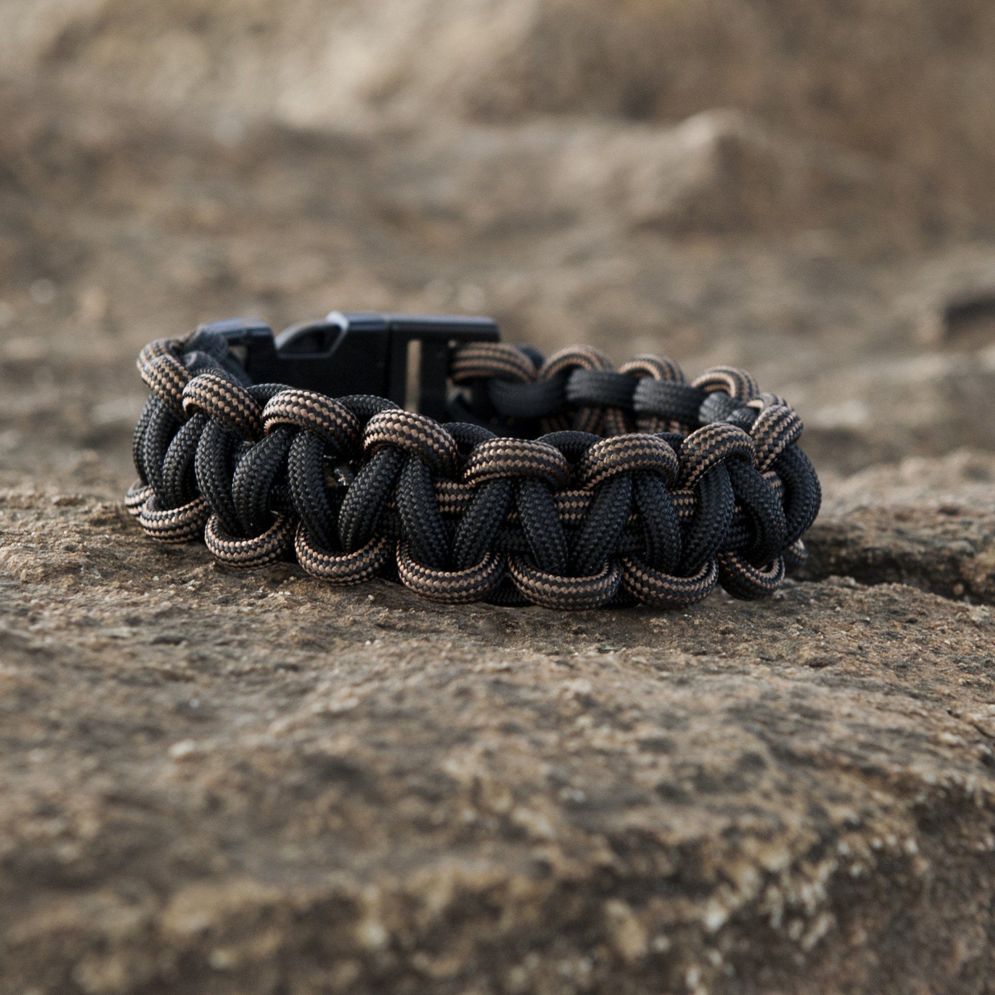 Close-up of ACU dark earth SurvivorCord showcasing the intertwined fibers in a wristband construction