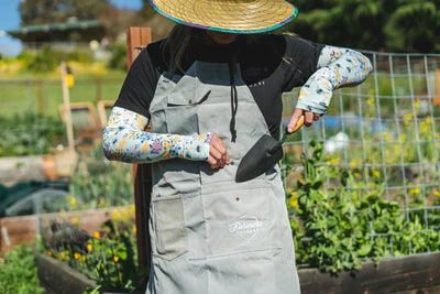 A gardener utilizing Farmers Defense gardening gear