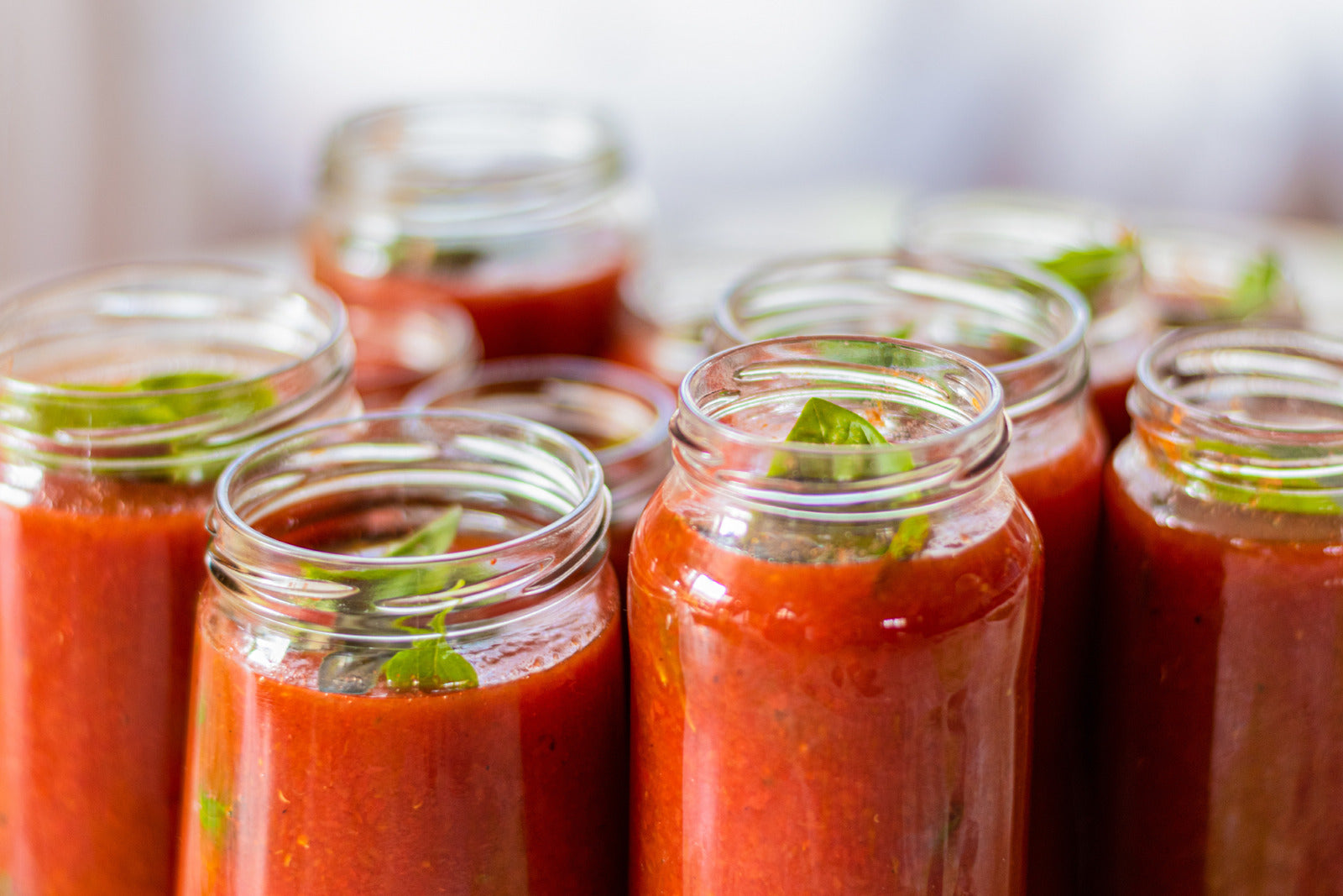 Mason jars with sauce ready for preserving