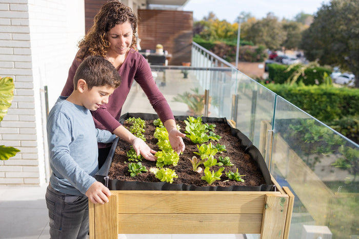 Mother and son tending to a balcony garden