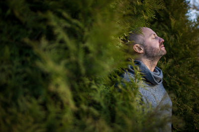 A man practicing permaculture practices in a garden