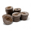 Close-up of many Jiffy Pellets (42mm) stacked neatly with visible fibers