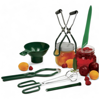 Canning and dehydrating kit with green utensils alongside fresh produce