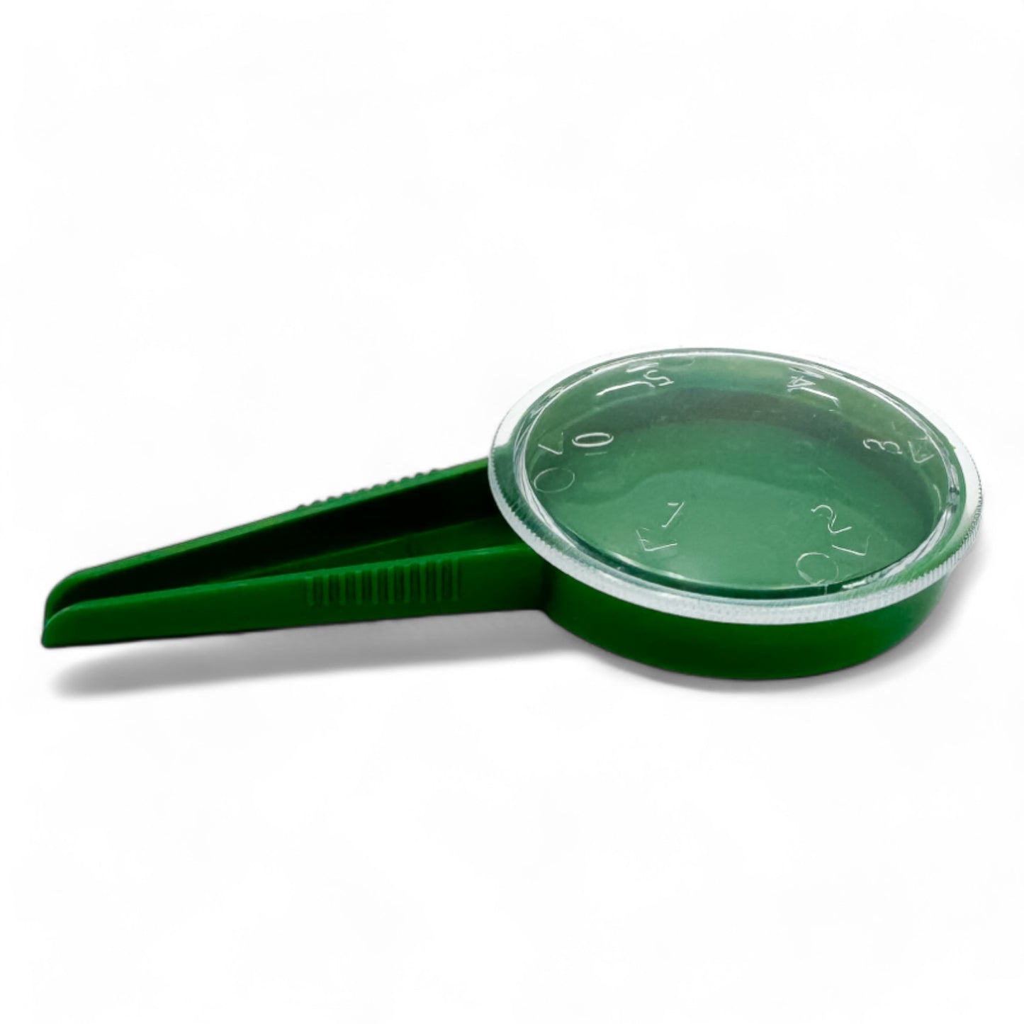 Handheld seed dispenser with green lid and integrated spoon