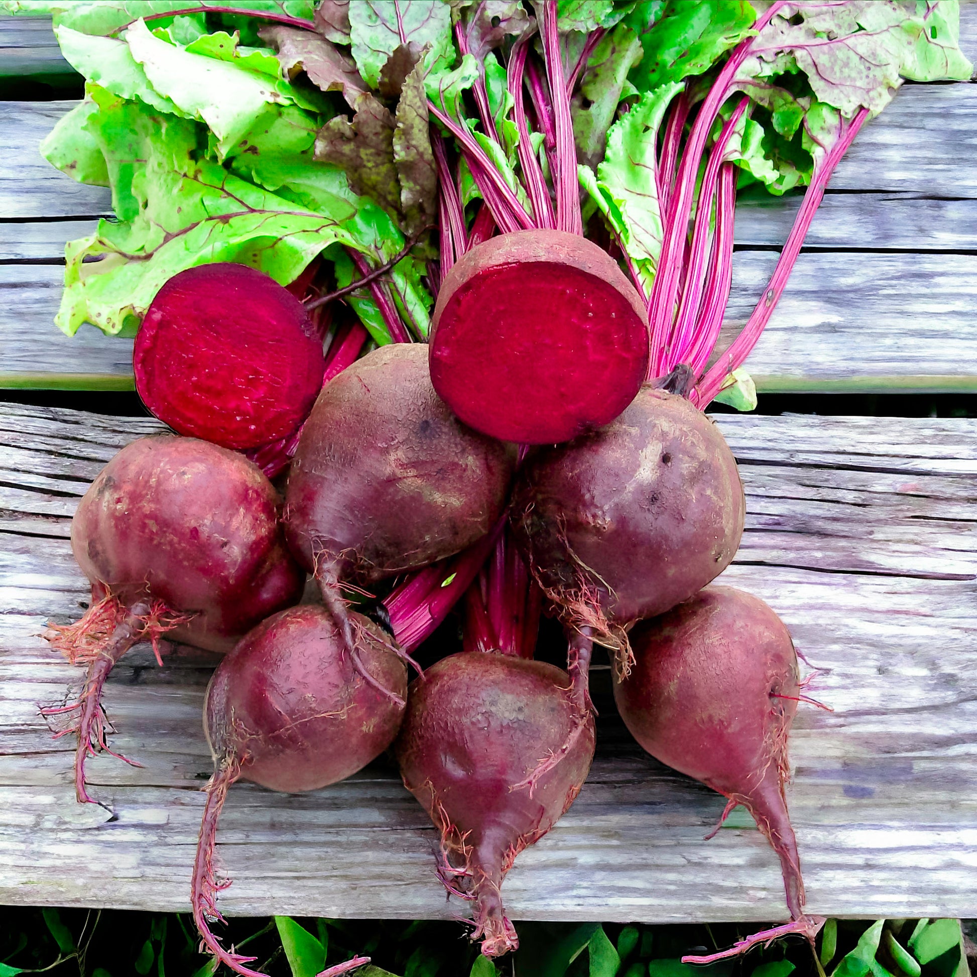 Heirloom Detroit Dark Red beets scattered on a wooden surface