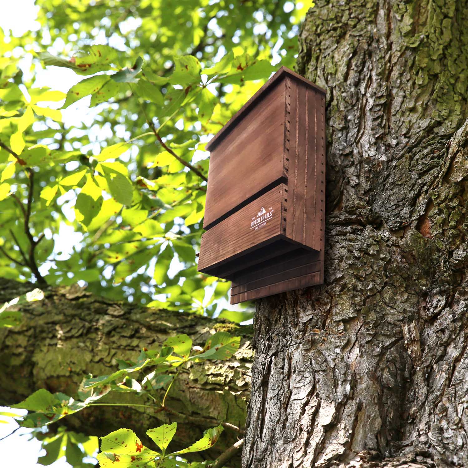 Outer Trails™ Multi Chamber Bat House installed on a tree in a natural habitat