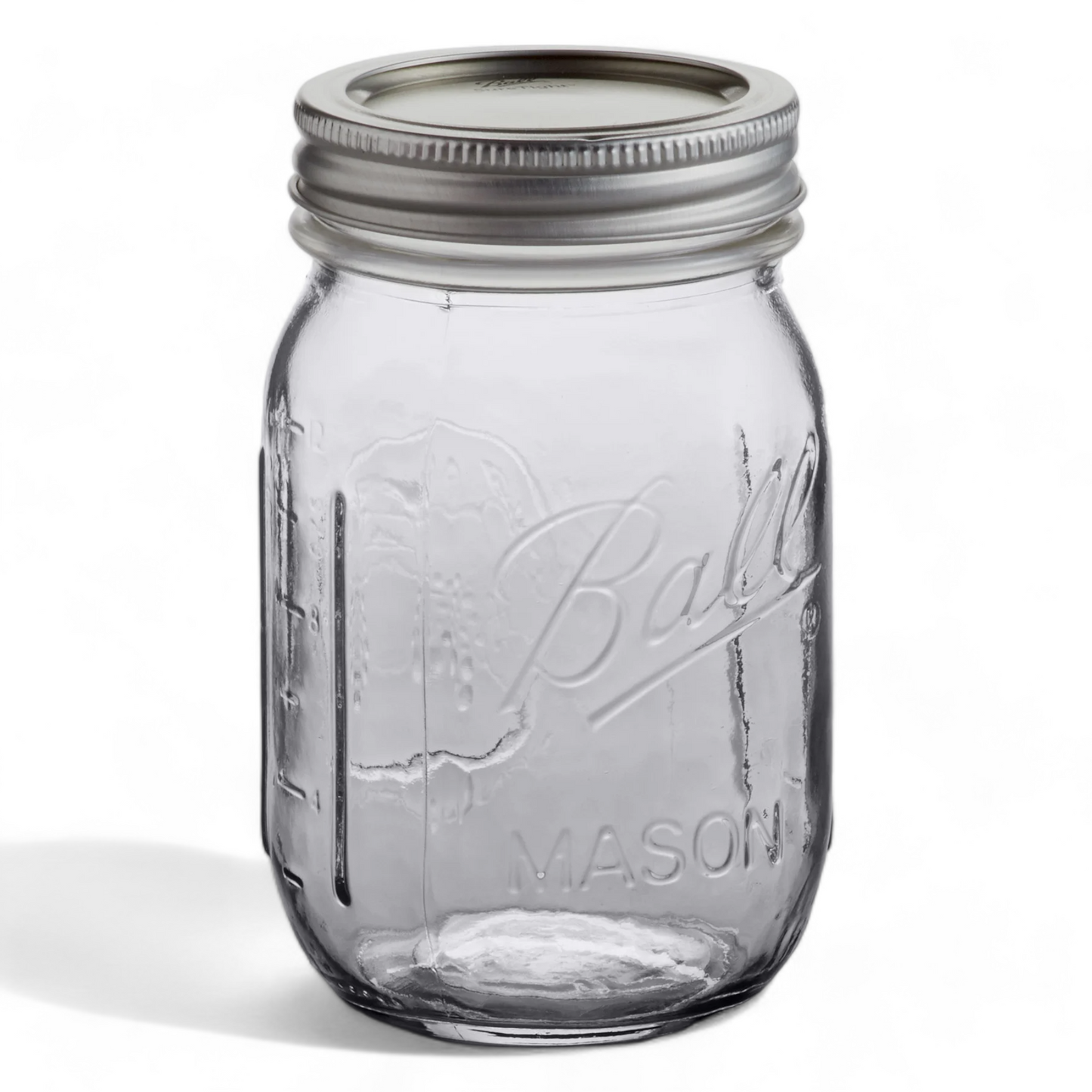 A standard Ball mason jar with a metal lid and measuring levels showing