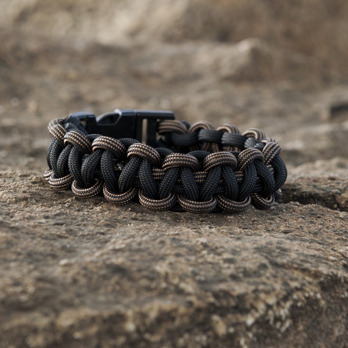 Close-up of black SurvivorCord showcasing the intertwined fibers in a wristband construction