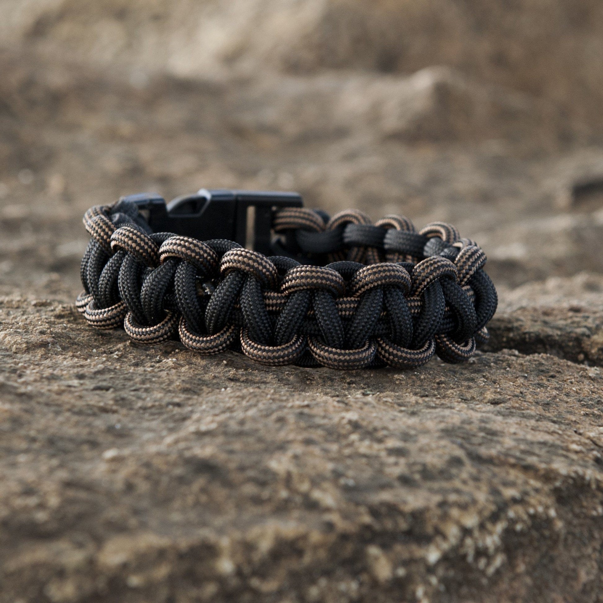 Close-up of black SurvivorCord showcasing the intertwined fibers in a wristband construction